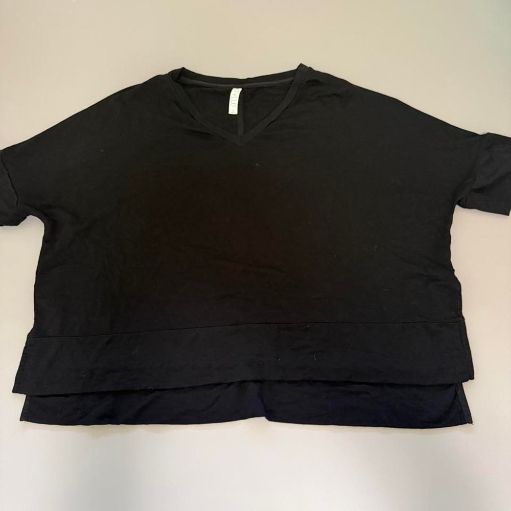 Black cropped top with a v-neck and short sleeves